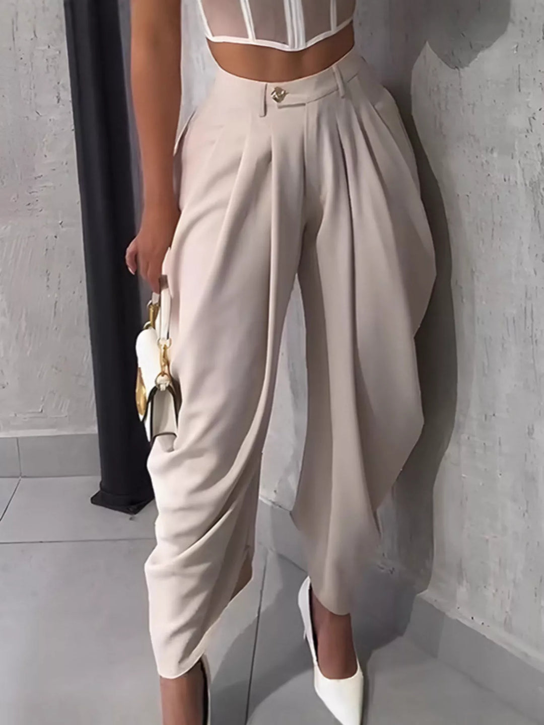 Women's harem pants in cream, high waisted with pleats, worn with white pumps