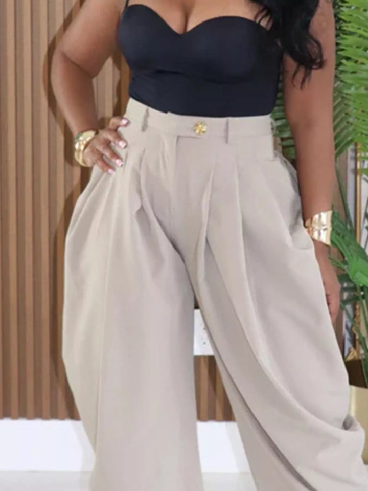 Stone harem pants closeup of the gold waist button and pleated front