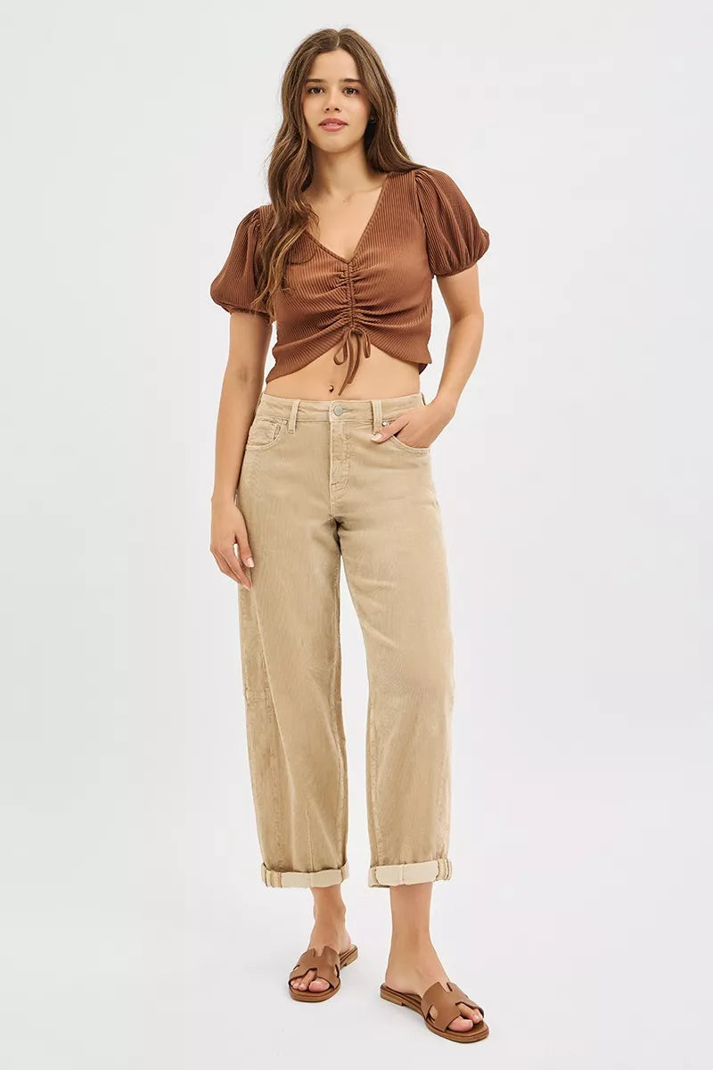 Tan high waisted cropped pants styled with a brown ruched top and sandals