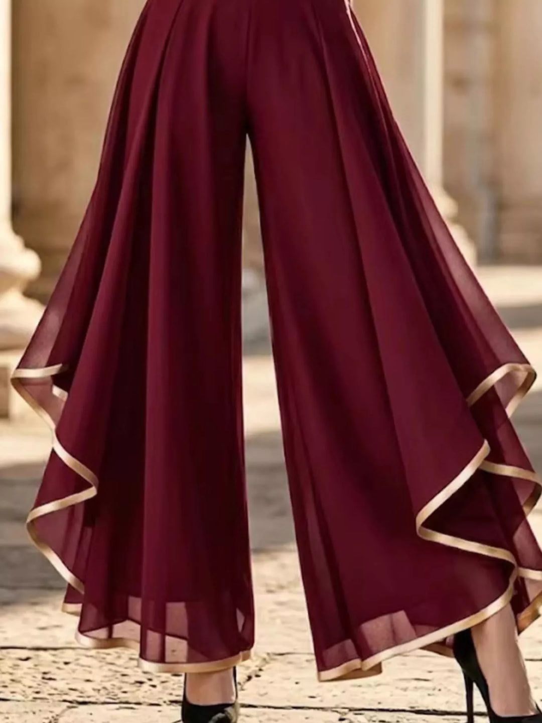 Burgundy wide leg pants with draped ruffle overlay, lower body view with heels