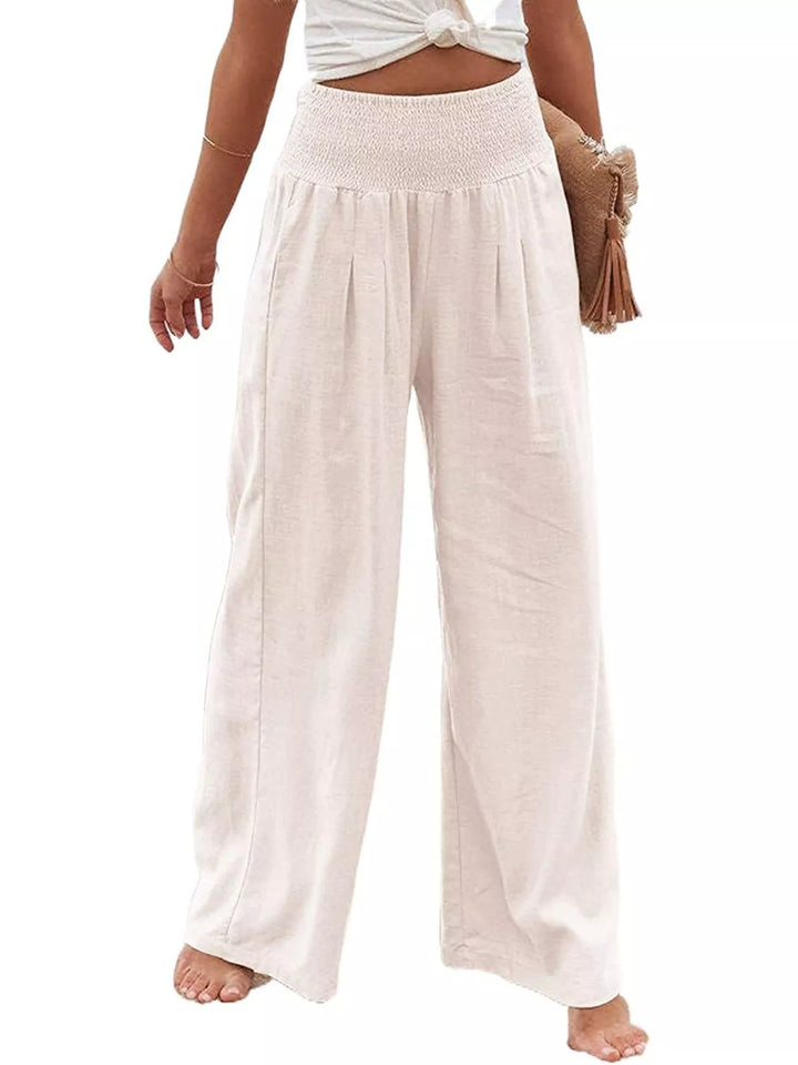 Cream wide leg pants with smocked waist and pleats, front view on white