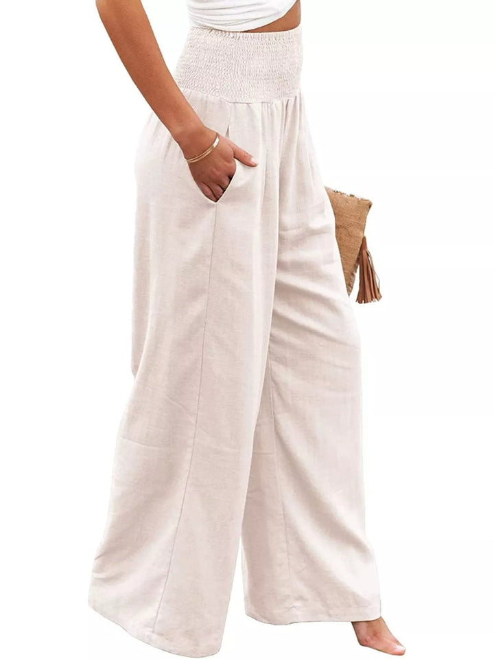 Cream high waisted pants with hand in pocket, angled view