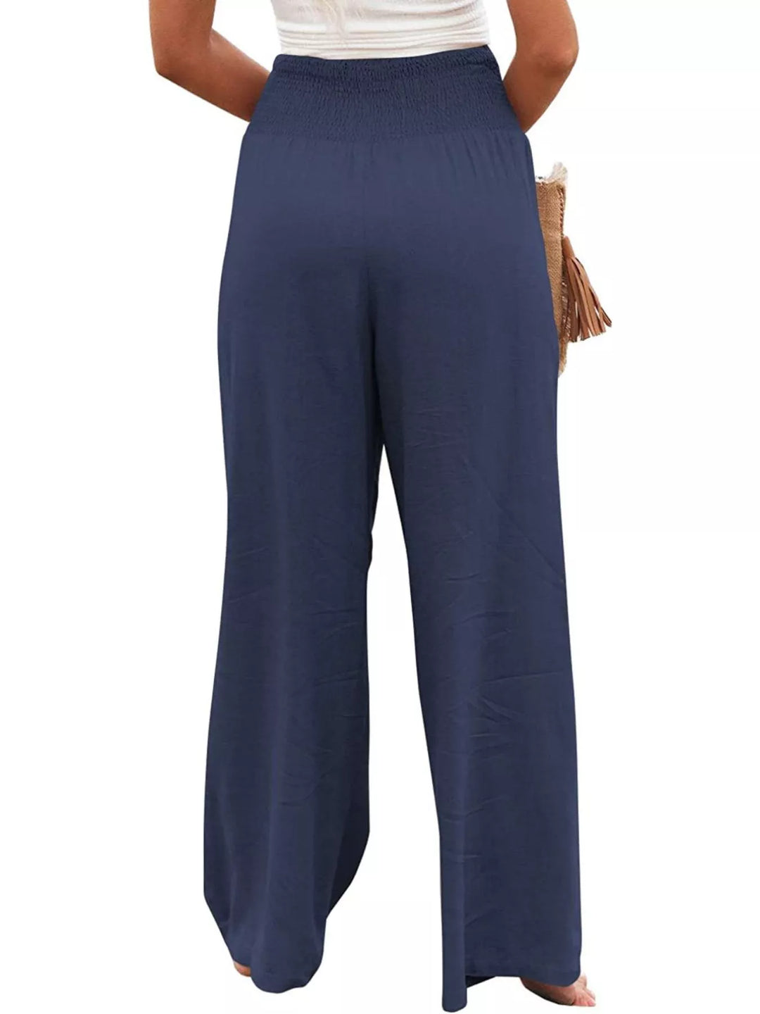 Navy smocked waist wide leg pants, rear view on white