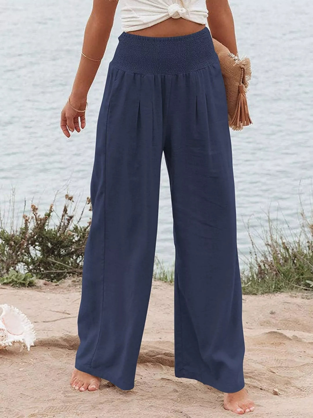 Navy high waisted wide leg pants with smocked waist, front view
