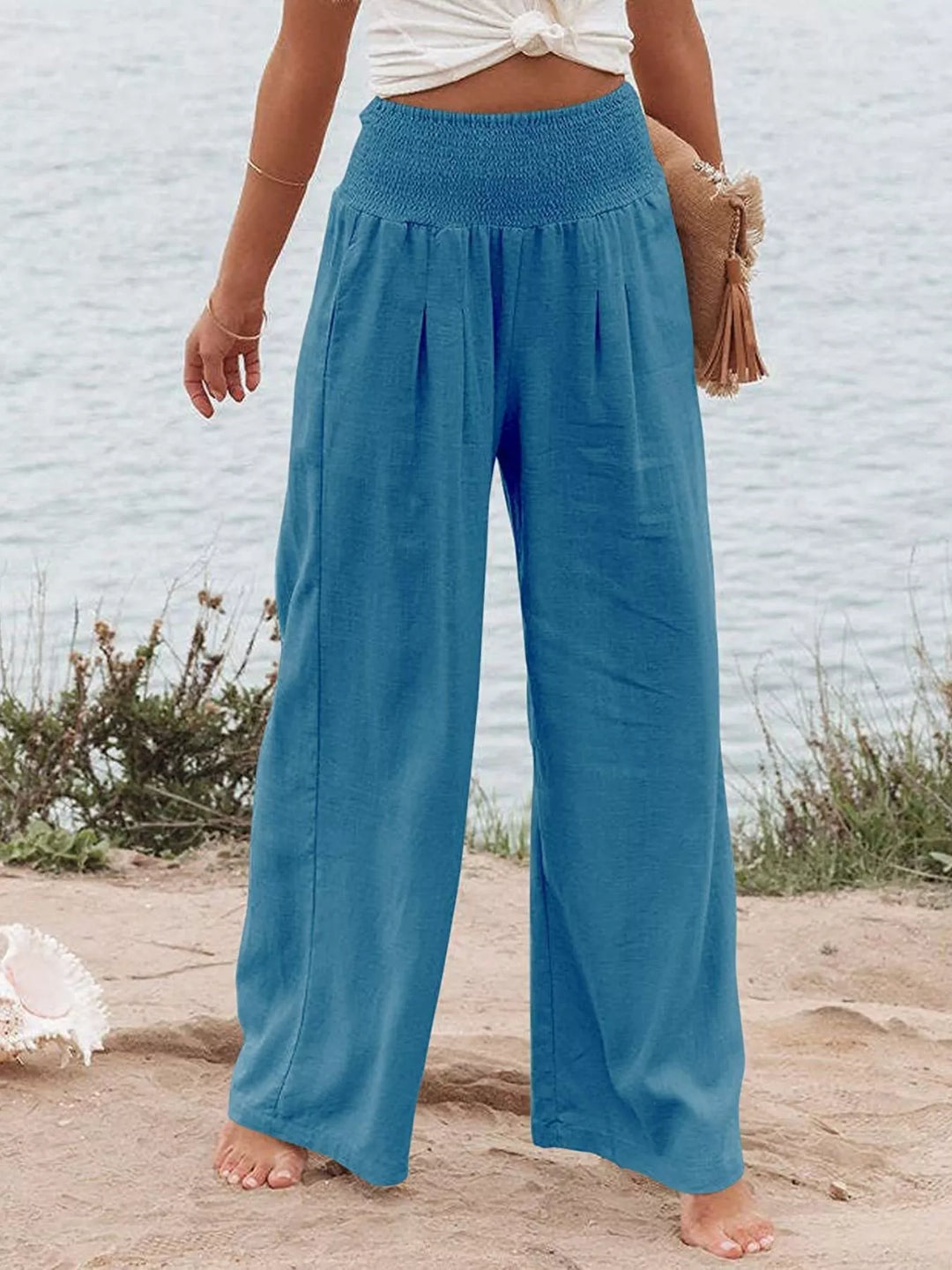 Ocean blue wide leg pants with smocked waist and pleats, front view