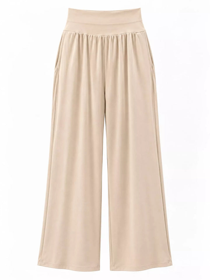 Beige high waisted wide leg pants, laid flat showing the wide legs