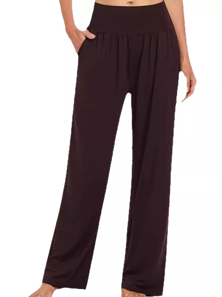 Dark brown high waisted wide leg pants, front view with hand in pocket