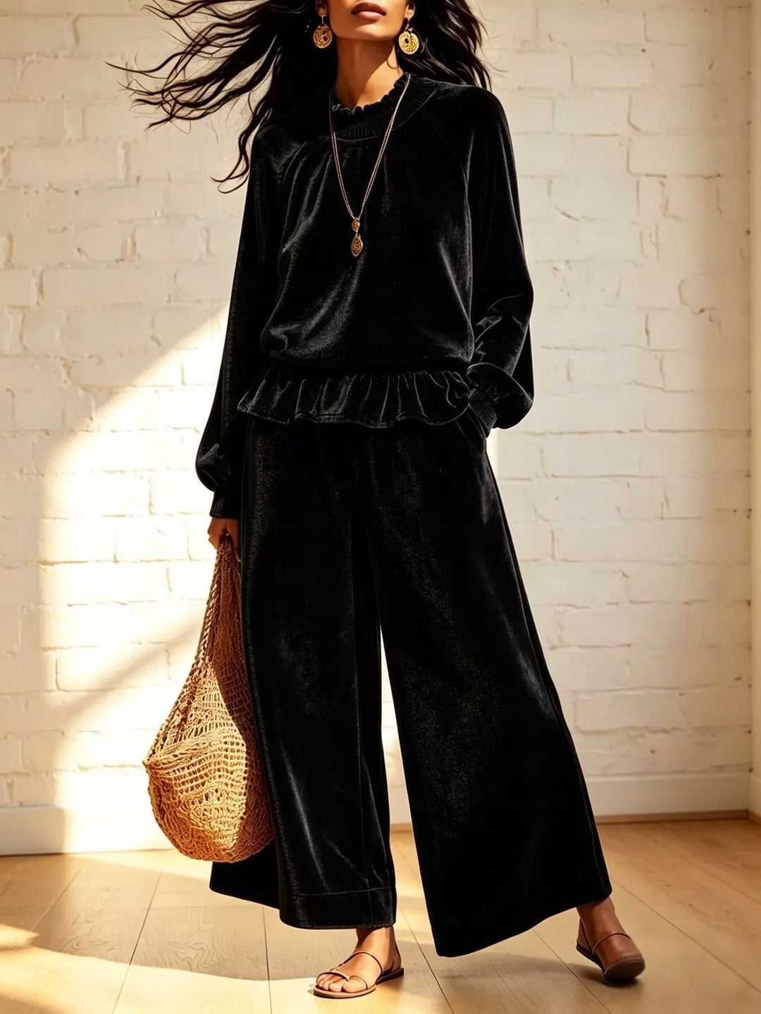 Black holiday outfit with peplum top and wide leg pants, front view