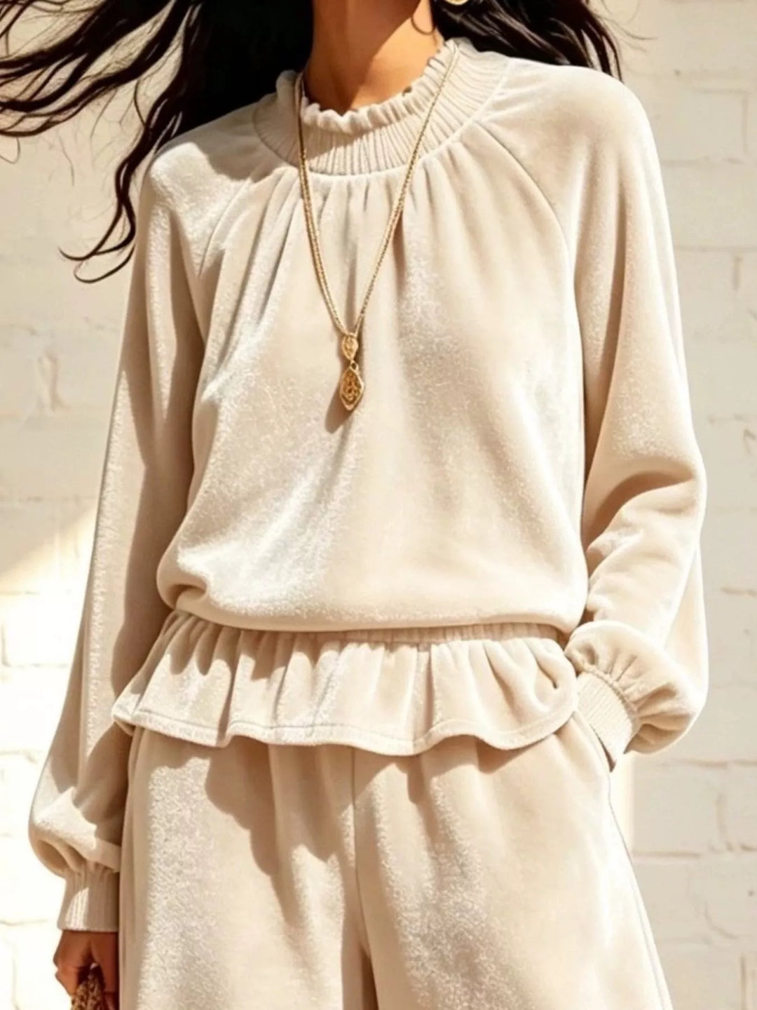 Close-up of the cream peplum top ruffled neckline and hem