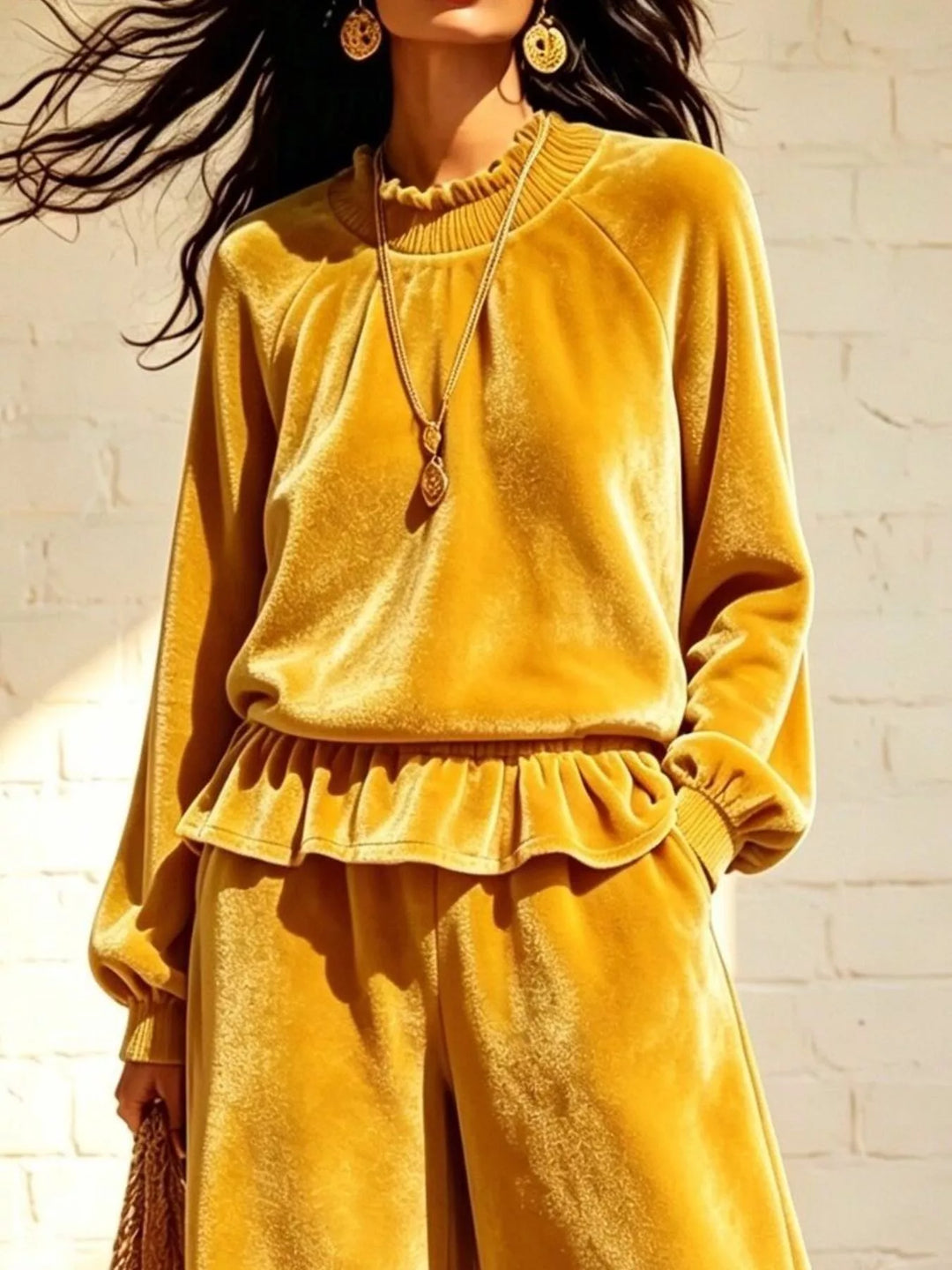 Mustard velvet-look peplum top, close-up of the ruffle hem and necklace
