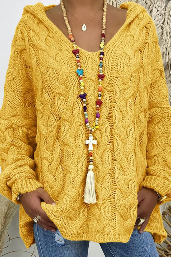Mustard yellow cable knit hooded sweater, close-up of the V neck and bead necklace