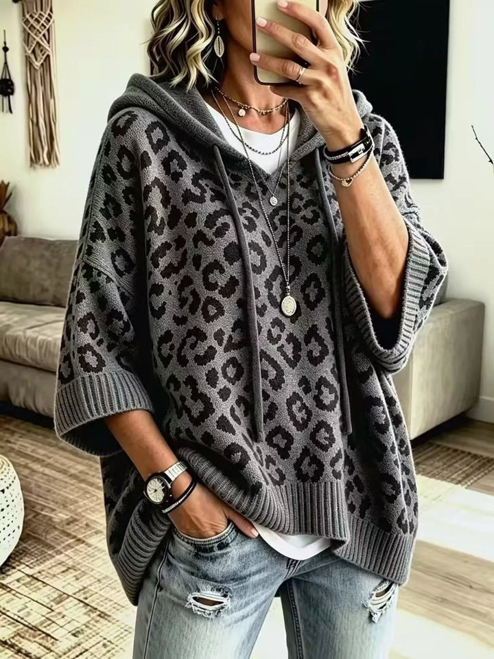 Dark gray hooded sweater with an oversized leopard jacquard pattern, front view