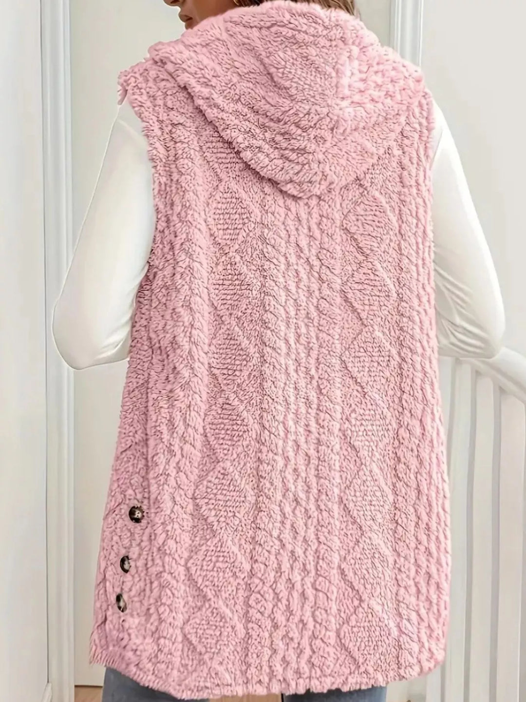 Back view of the blush pink hooded vest with cable pattern