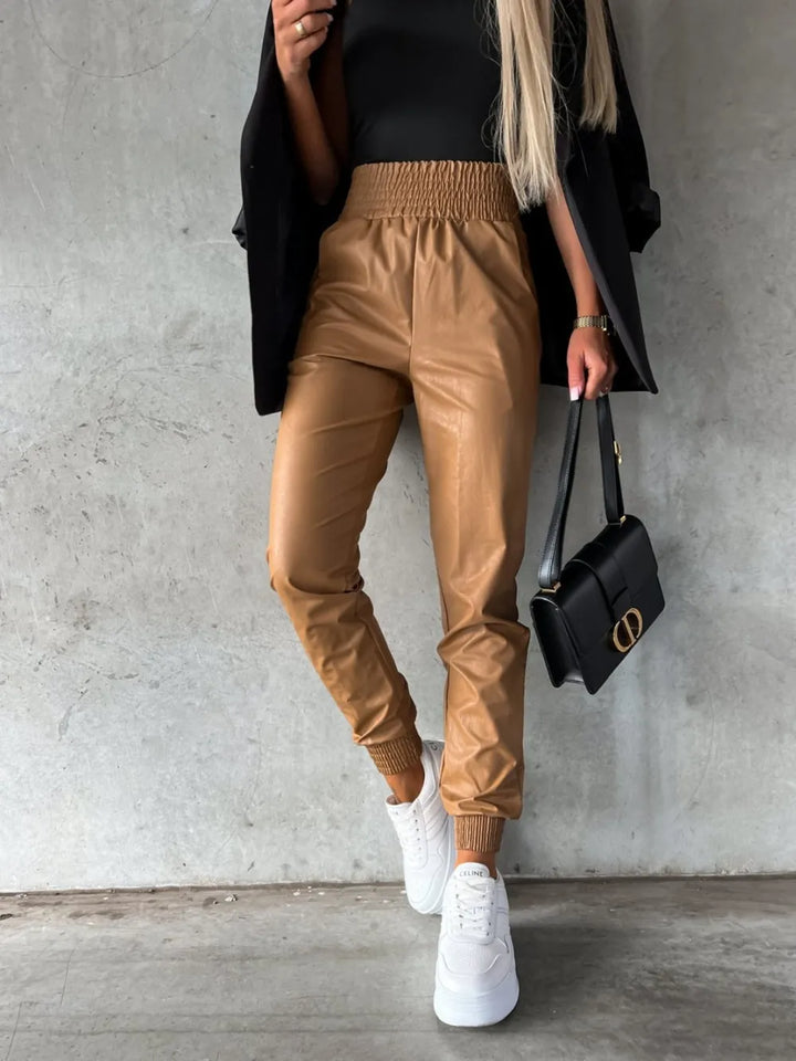 Camel jogger pants with a smocked waist, styled with a black blazer