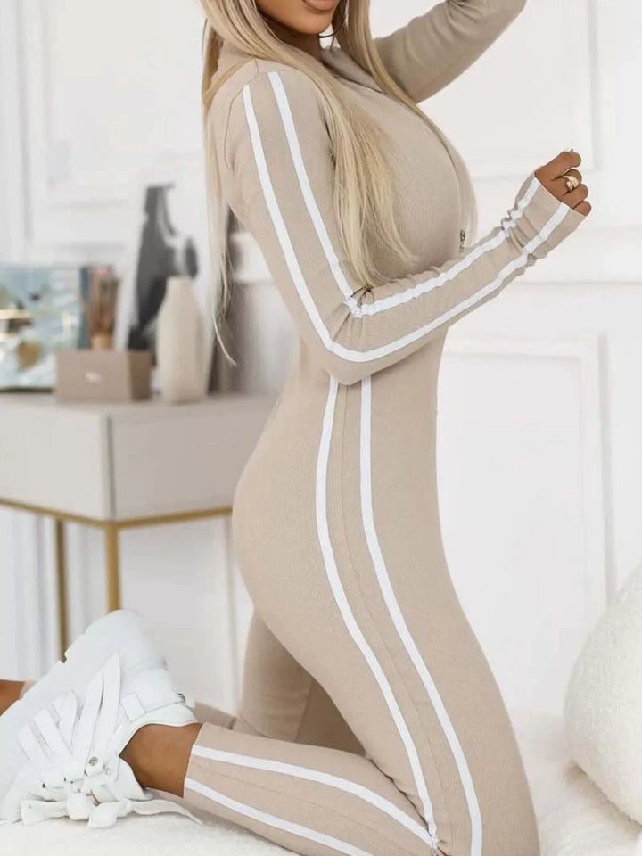 Beige long sleeve jumpsuit with contrast stripes, kneeling pose