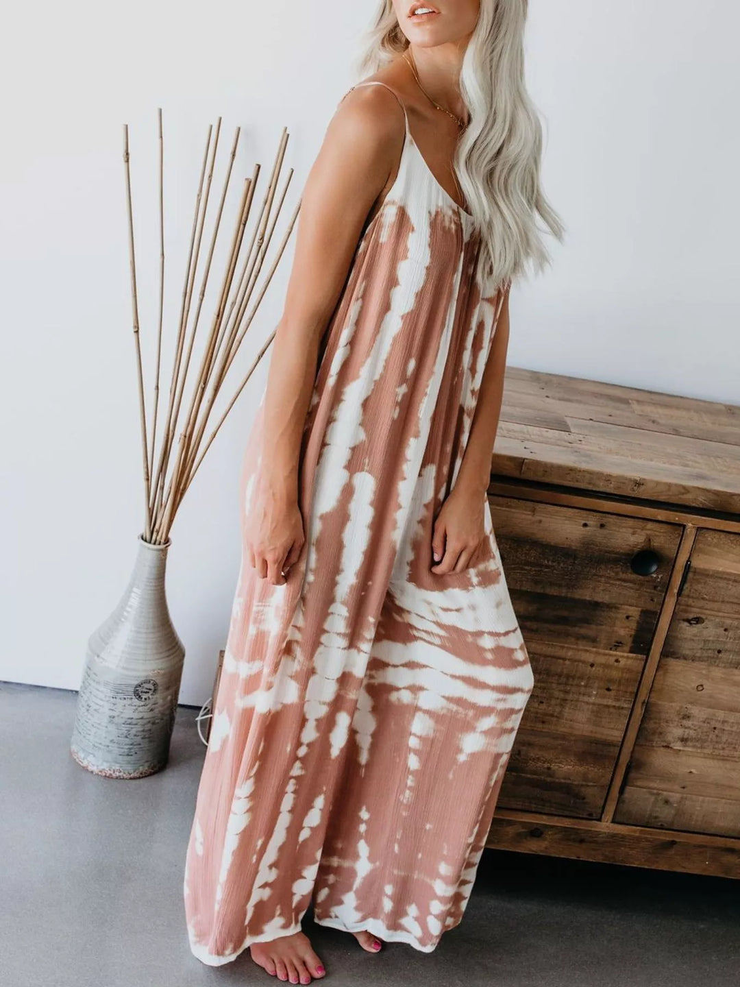 Coral sleeveless jumpsuit, side angle with relaxed wide legs