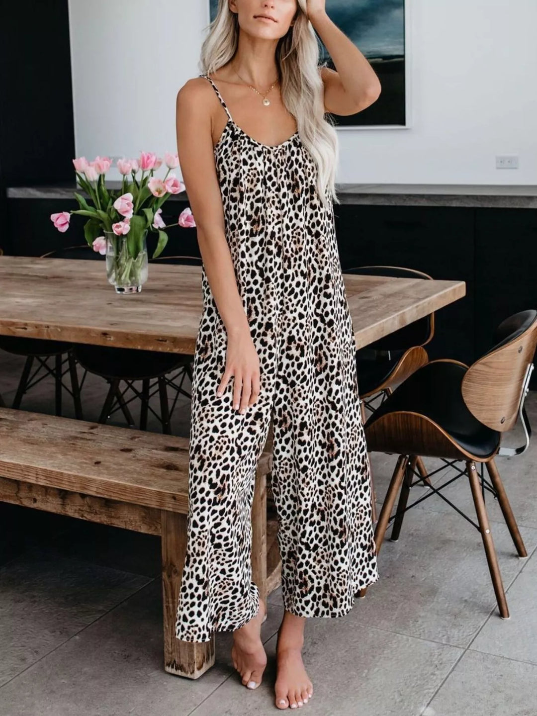 Leopard sleeveless wide leg jumpsuit, front view with one hand on the head