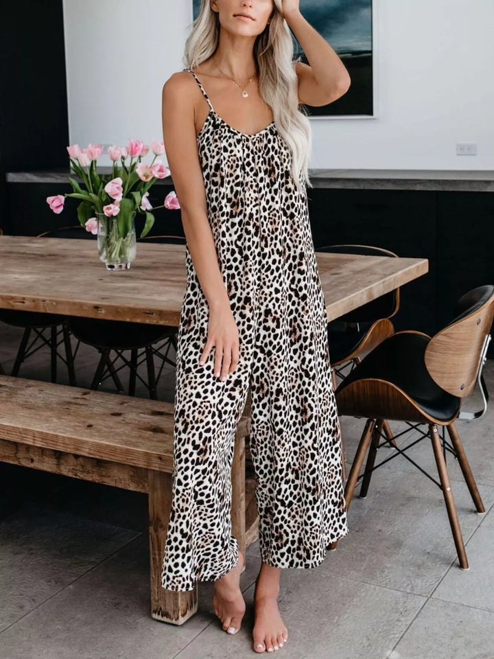 Leopard sleeveless wide leg jumpsuit, front view with one hand on the head