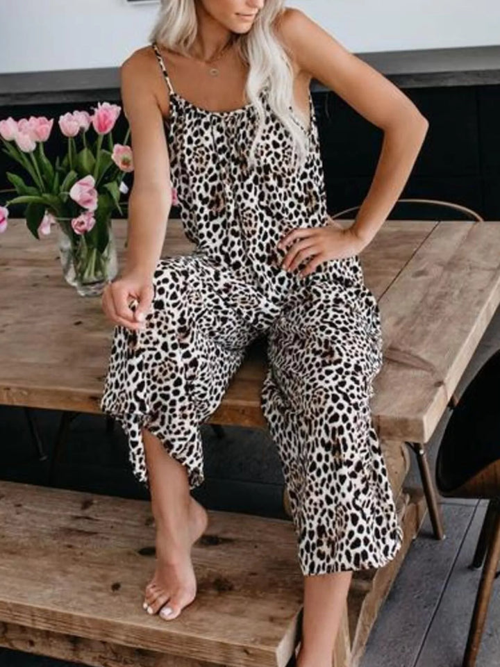 Leopard print jumpsuit, model seated on a wooden bench