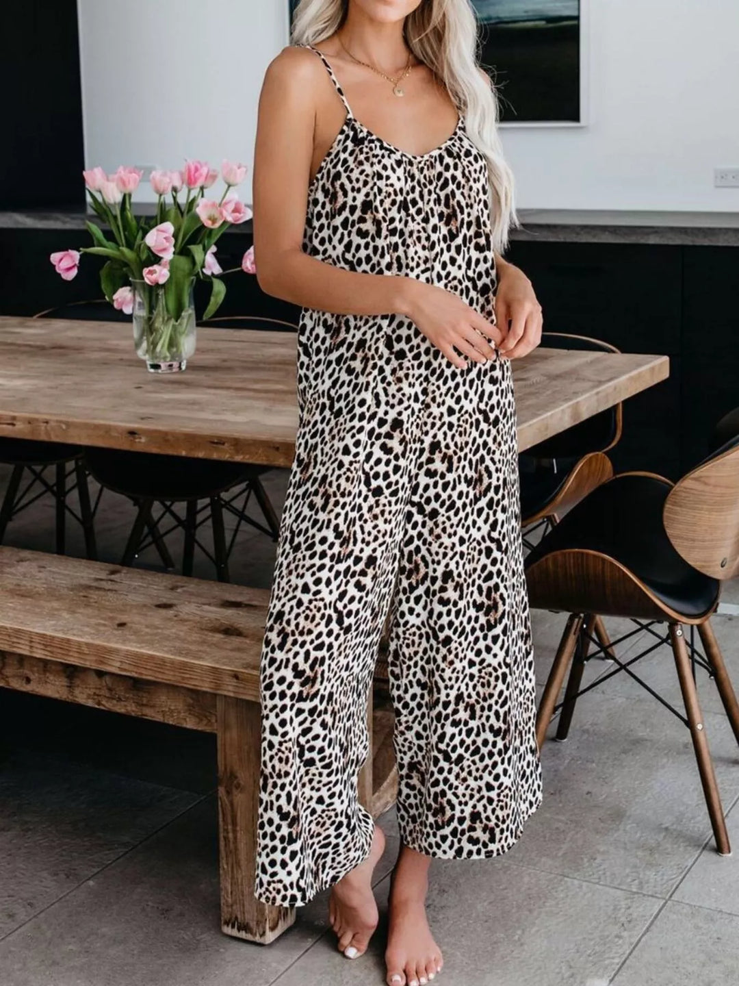 Leopard print wide leg jumpsuit in a relaxed three-quarter pose