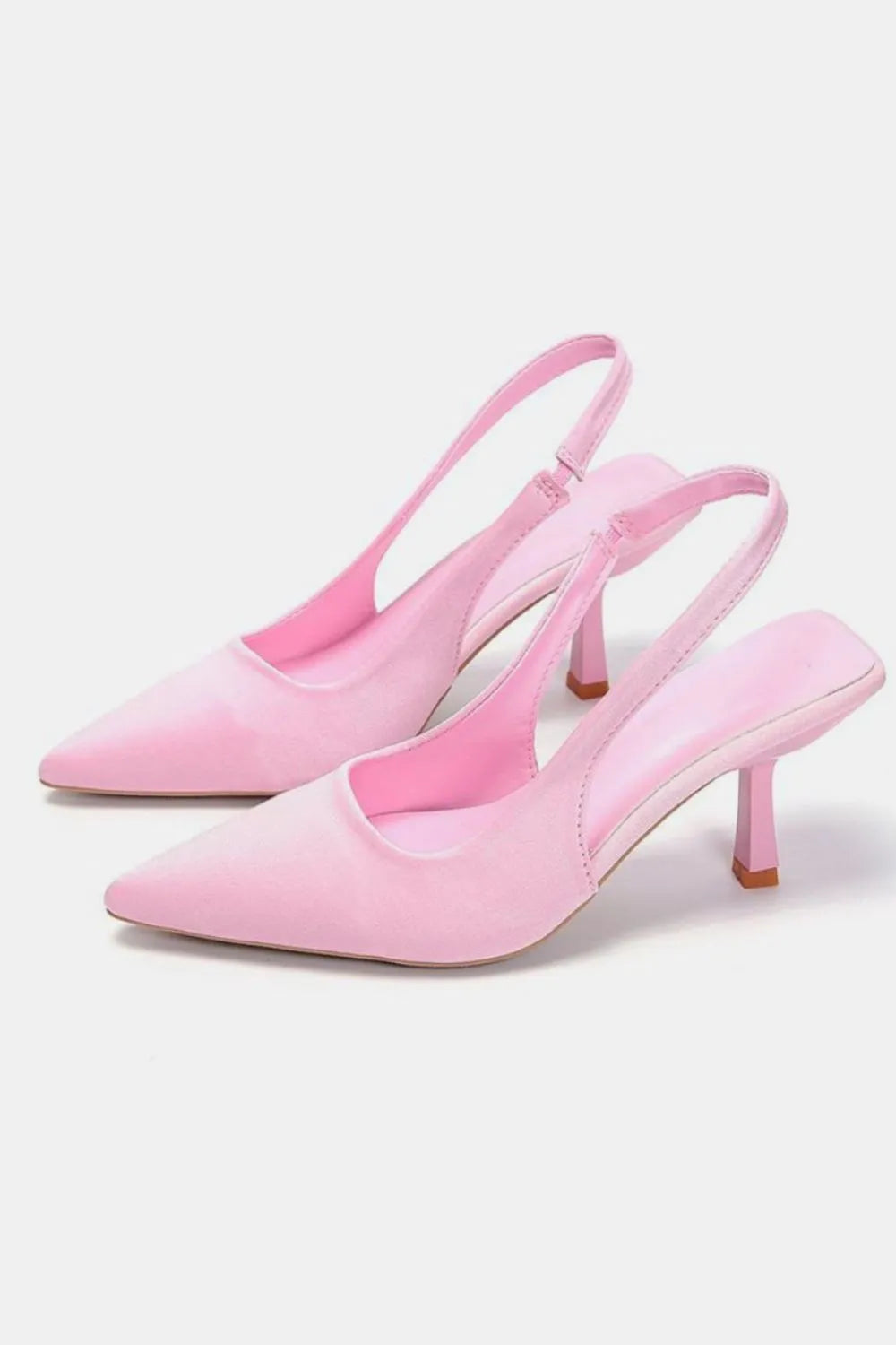 Light pink slingback kitten heels with a pointed toe, pair side view
