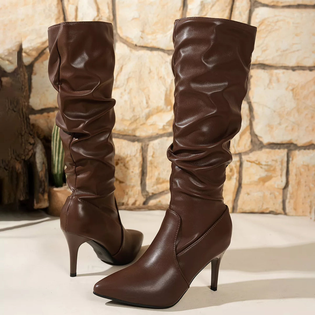 Back view of brown slouchy knee high boots with stiletto heels