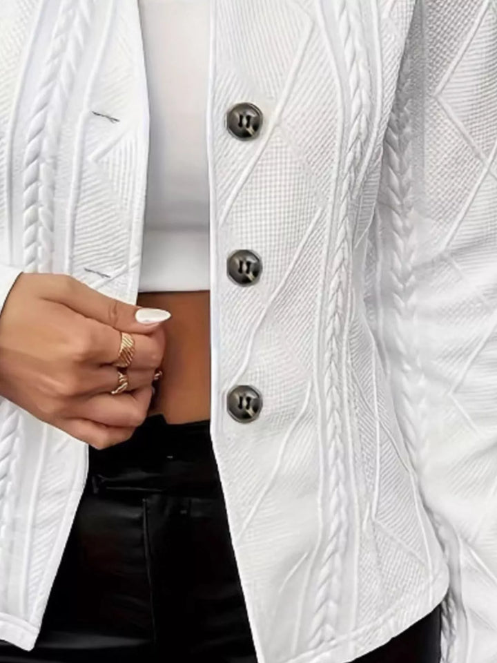 Close-up of the white blazer buttons and cable texture