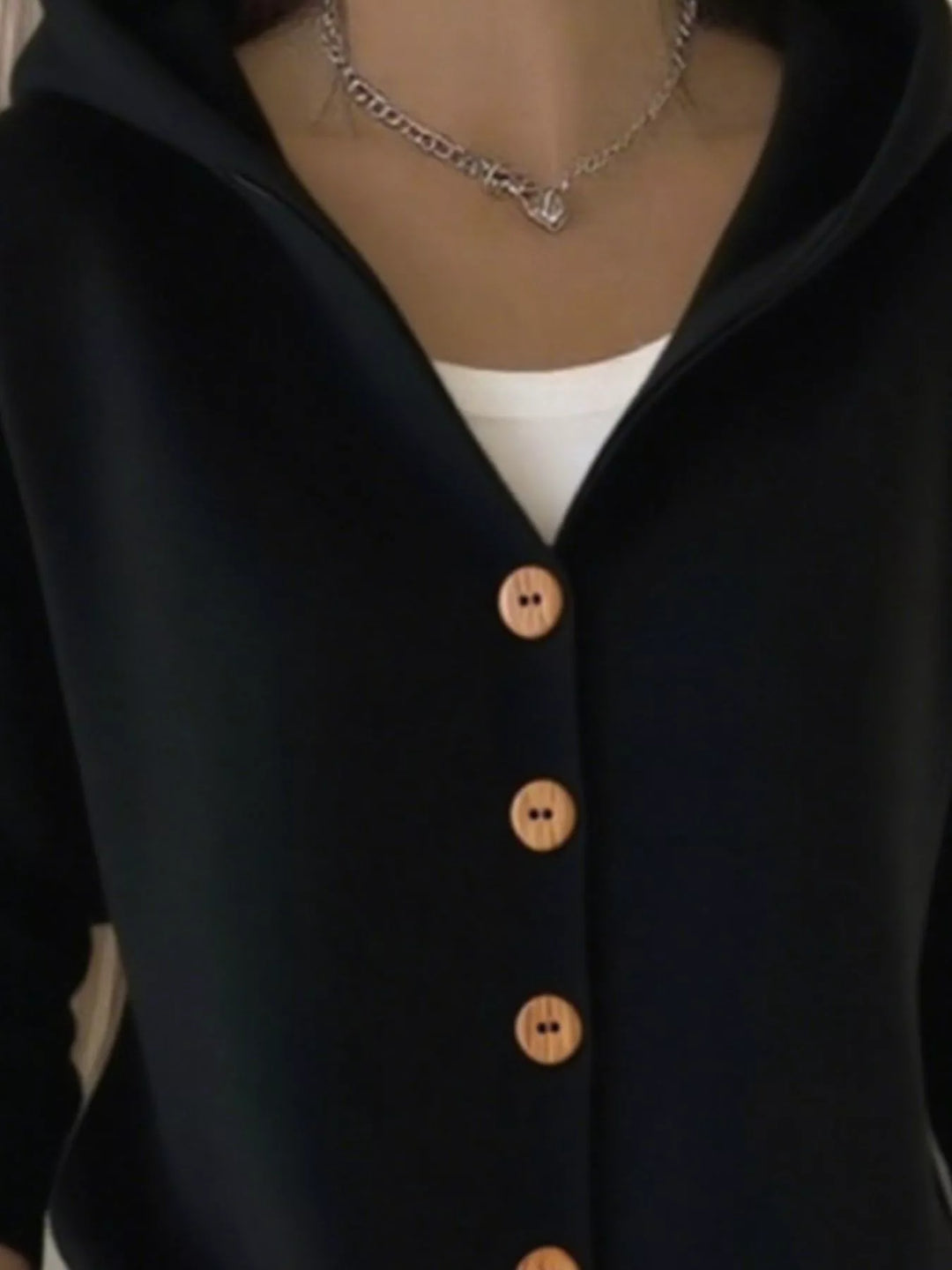Close-up of the black cardigan hood and V neckline