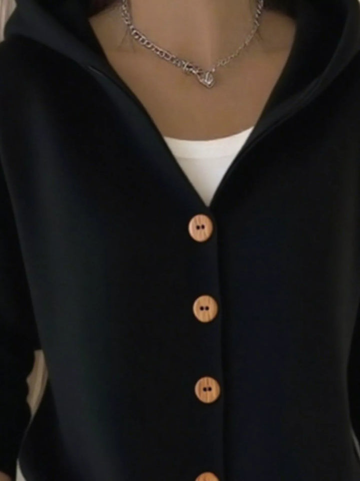 Close-up of the black cardigan hood and V neckline