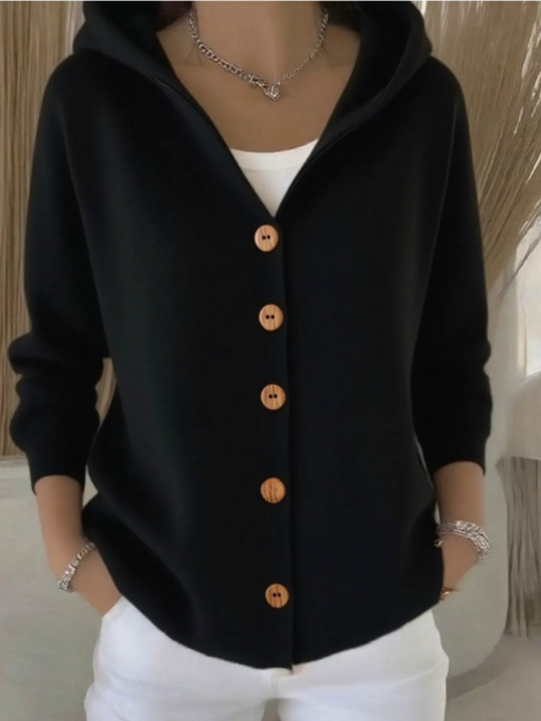 Black hooded knit cardigan with wooden-look buttons, front view