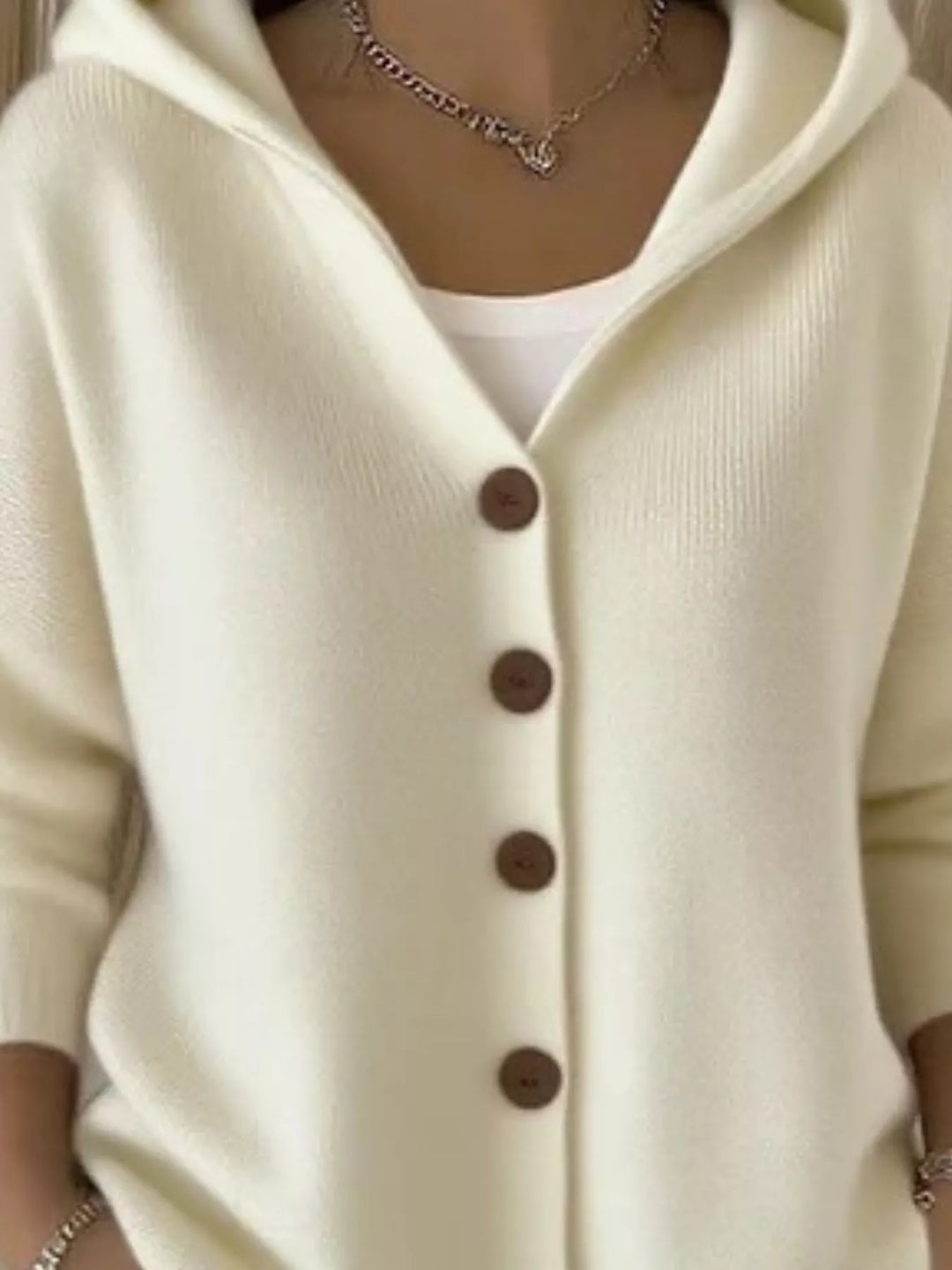 Close-up of the cream cardigan hood and V neckline