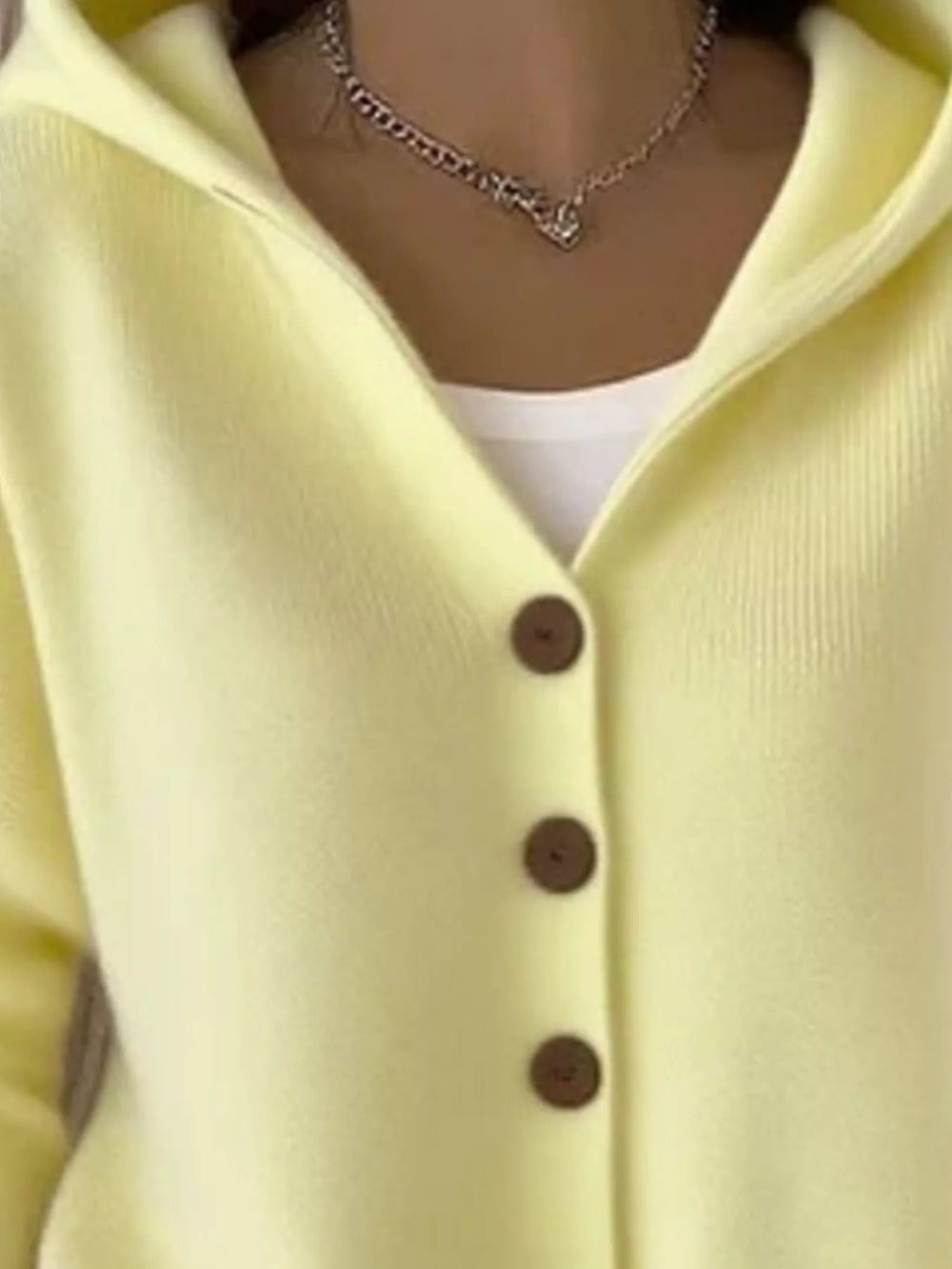 Close-up of the lemon yellow cardigan hood and V neckline