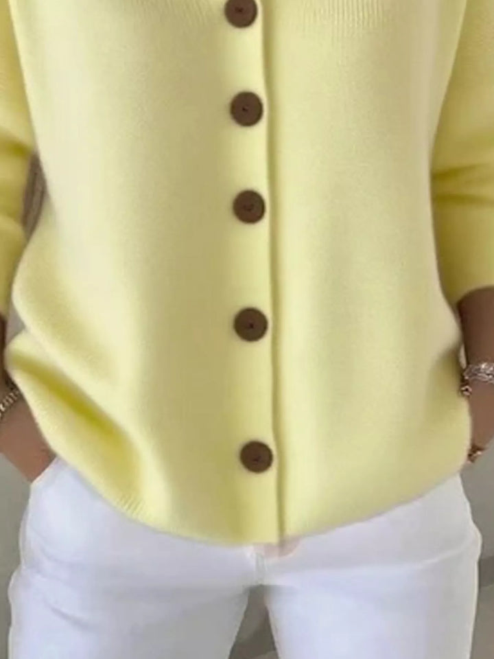 Detail of the lemon yellow cardigan button front and ribbed hem