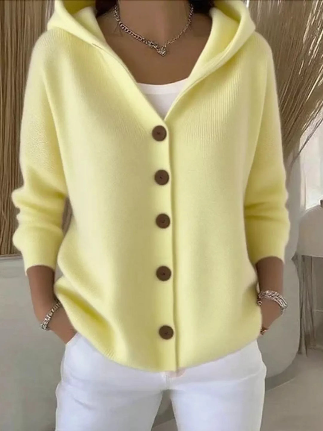 Women's knit cardigan in lemon yellow with hood and wooden-look buttons