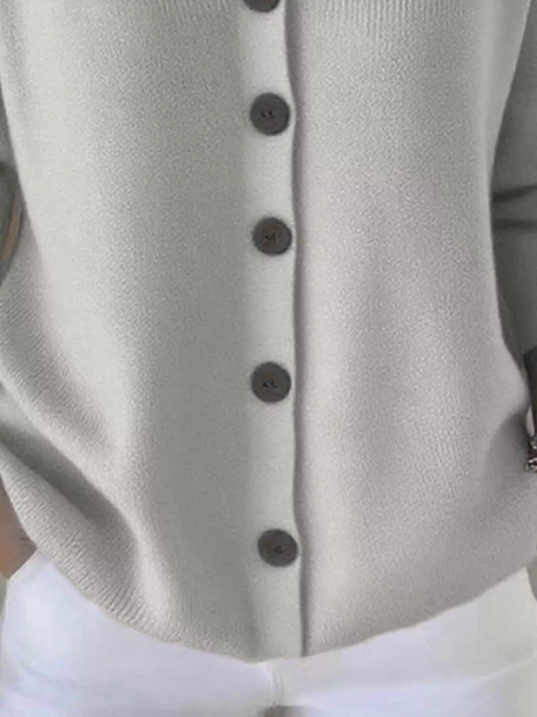Close-up of the light gray cardigan hood and V neckline