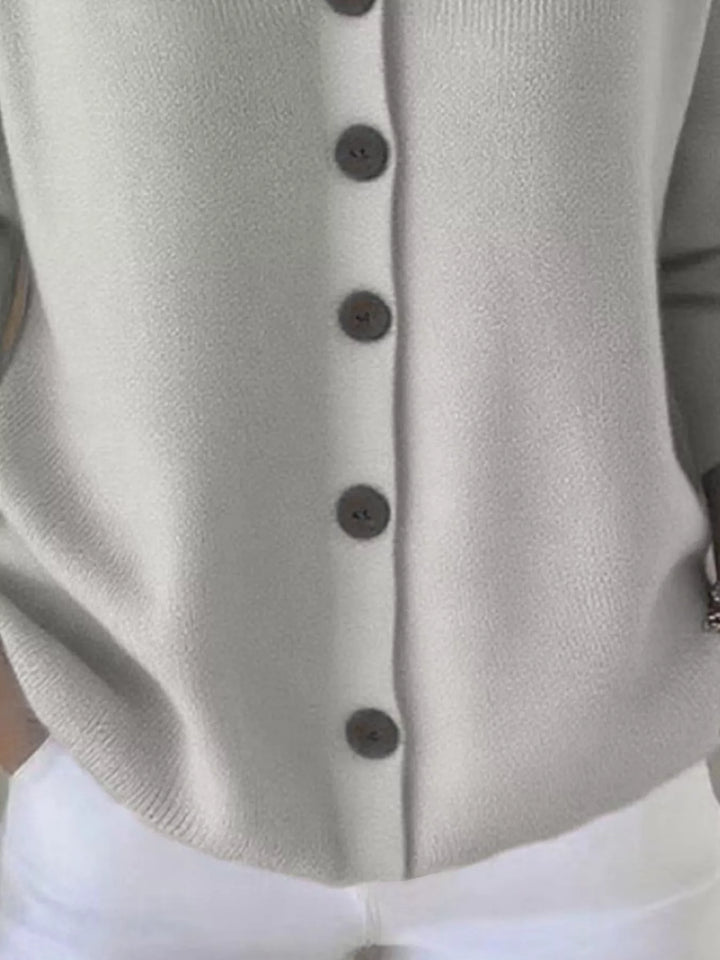Close-up of the light gray cardigan hood and V neckline