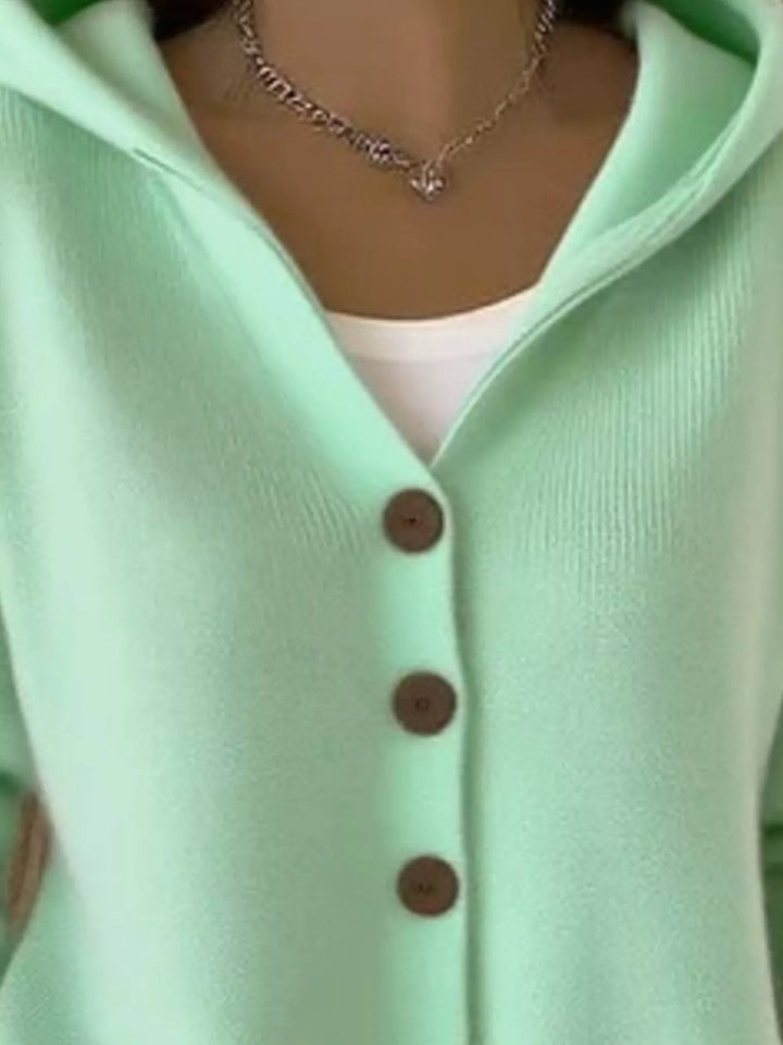 Detail of the mint green cardigan button front and ribbed hem