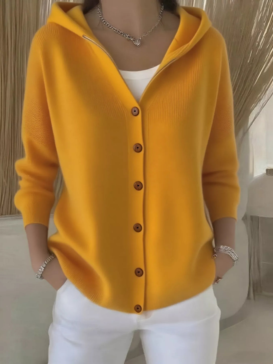 Mustard yellow hooded knit cardigan with wooden-look buttons, front view