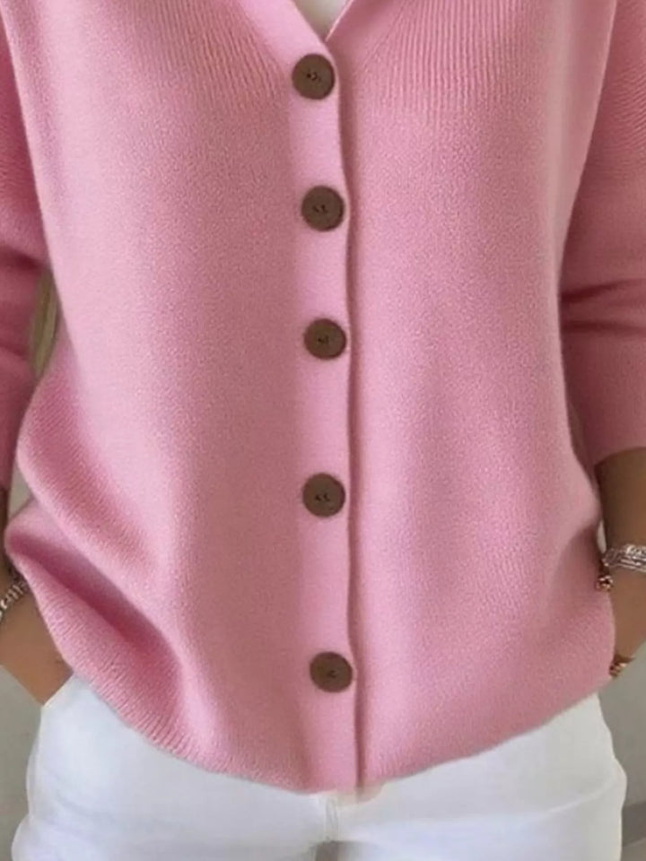 Detail of the pink cardigan button front and ribbed hem