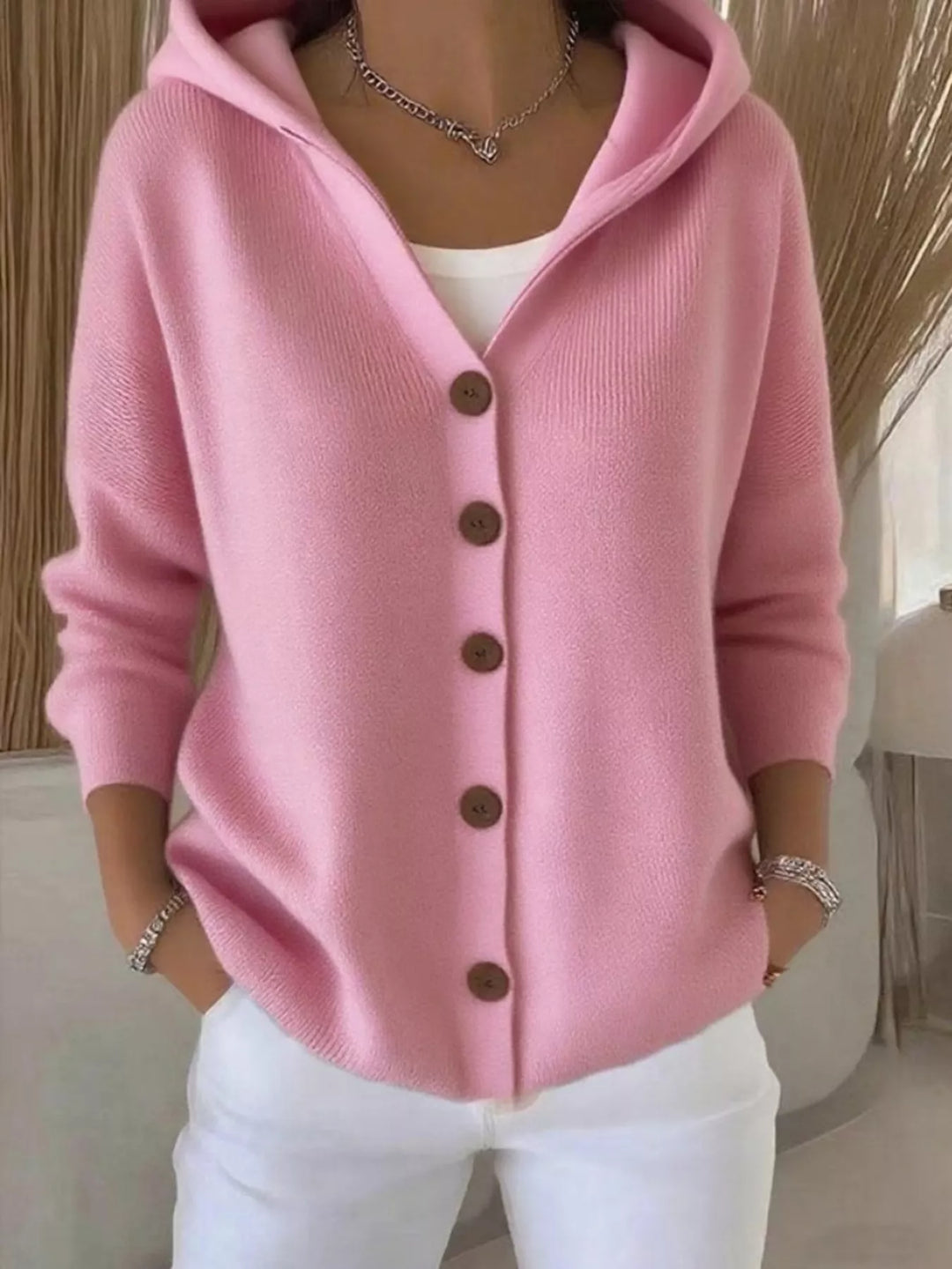 Pink hooded knit cardigan with wooden-look buttons, front view