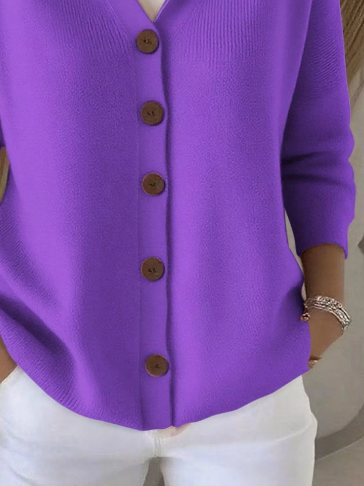 Detail of the purple cardigan button front and ribbed hem