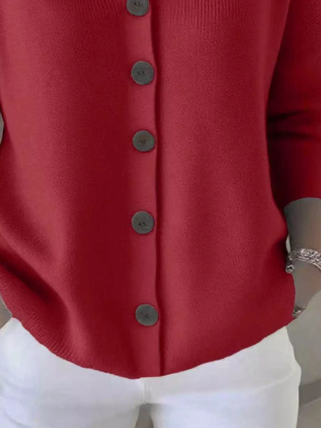 Detail of the red cardigan button front and ribbed hem