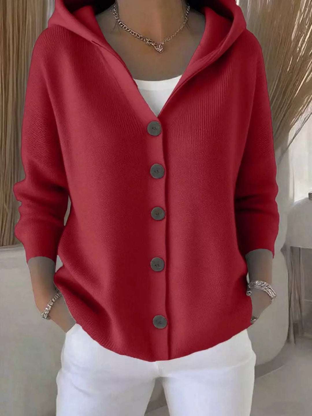 Red hooded knit cardigan with wooden-look buttons, front view