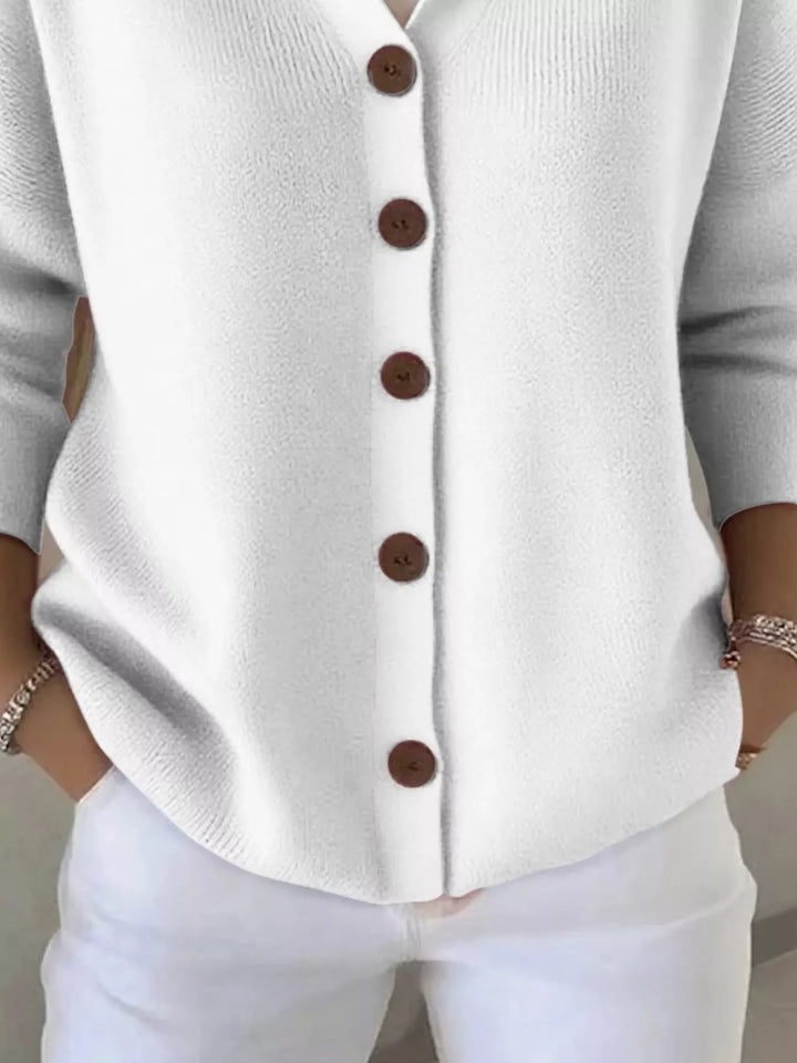 Detail of the white cardigan button front and ribbed hem