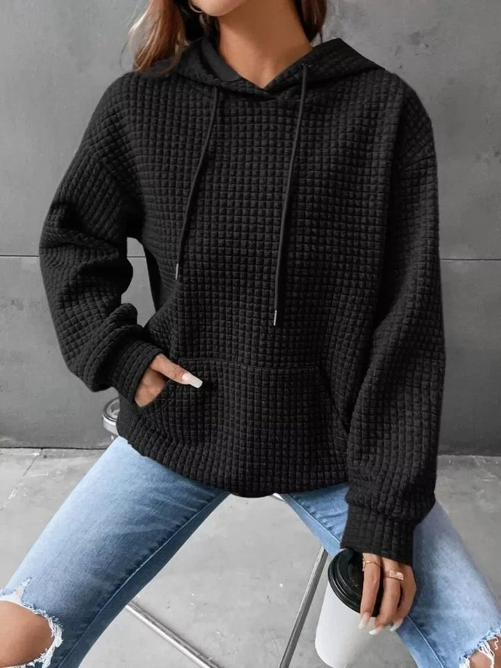 Waffle texture kangaroo pocket drawstring hood in black, front view