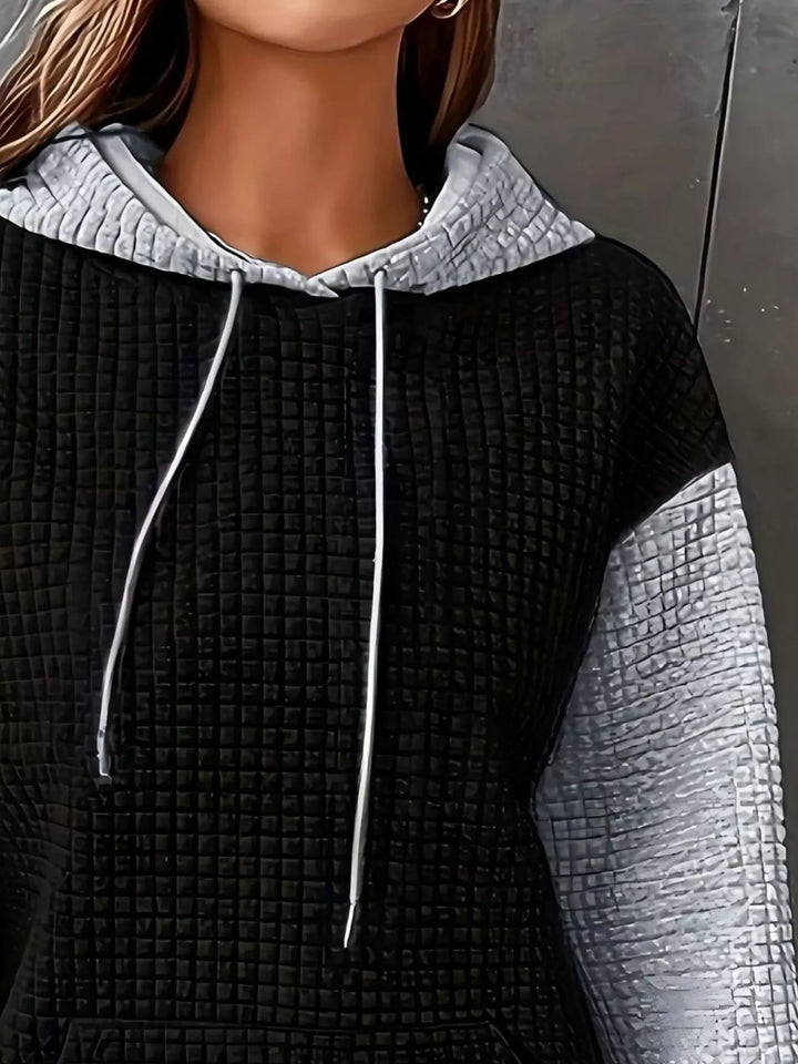 Waffle texture kangaroo pocket drawstring hood in black/white, close-up detail