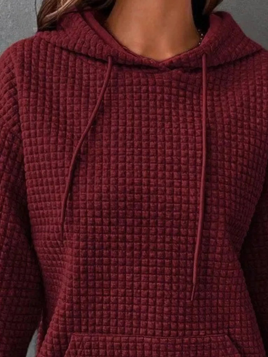 Waffle texture kangaroo pocket drawstring hood in dark red, close-up detail
