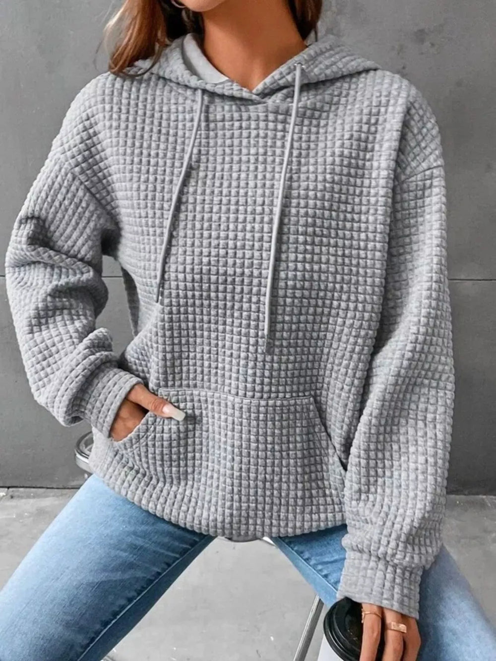 Waffle texture kangaroo pocket drawstring hood in grey, styled on model