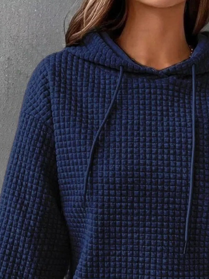 Waffle texture kangaroo pocket drawstring hood in navy, close-up detail