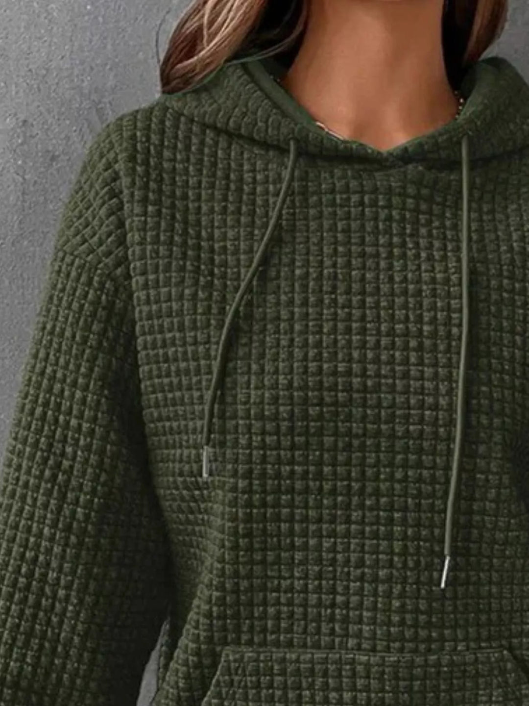 Waffle texture kangaroo pocket drawstring hood in olive green, close-up detail